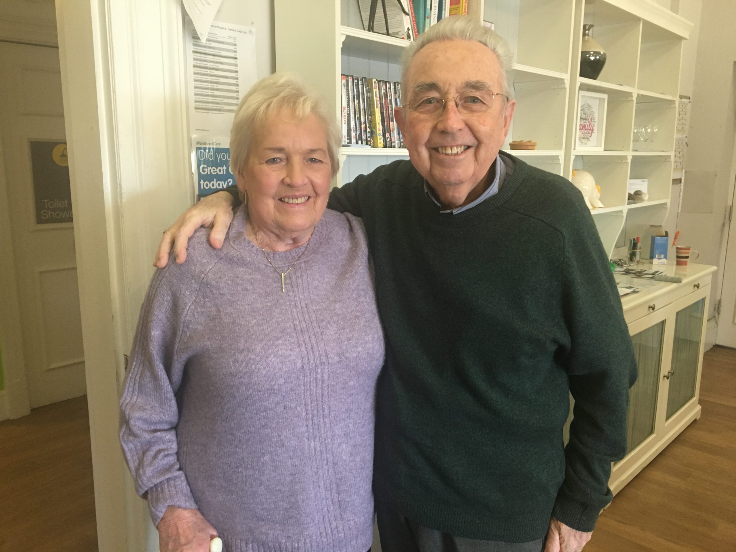 Man and woman standing next to each other smiling