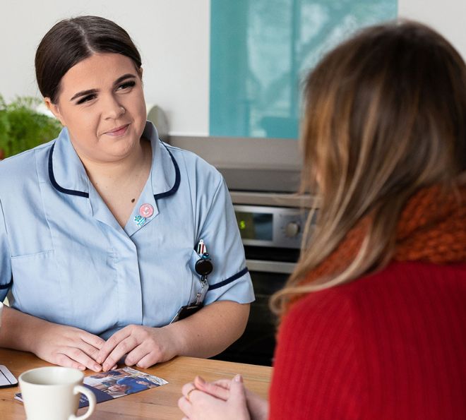 Hospice at Home Carer sat at kitchen table with patient