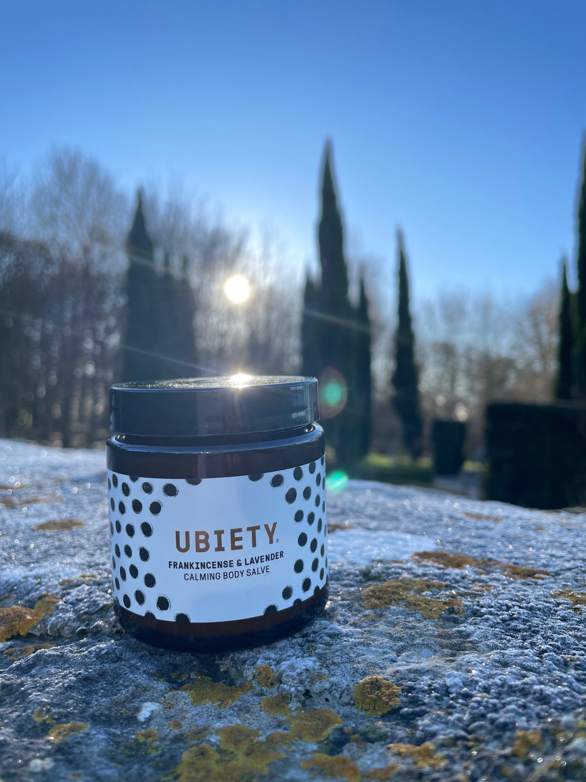Ubiety Calming Body Salve against Winsley grounds backdrop