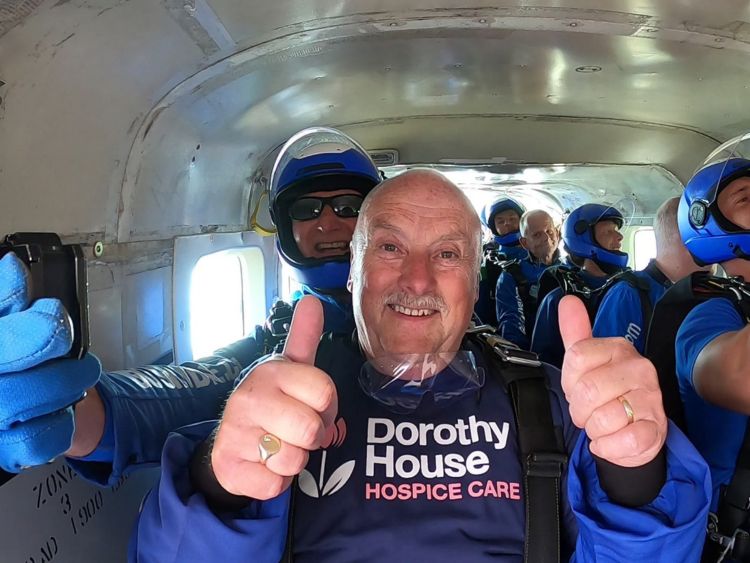 Kelvin smiling with thumbs up in skydive aircraft